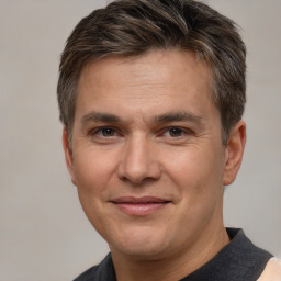 Joyful white adult male with short  brown hair and brown eyes