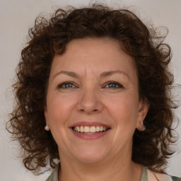 Joyful white adult female with medium  brown hair and green eyes