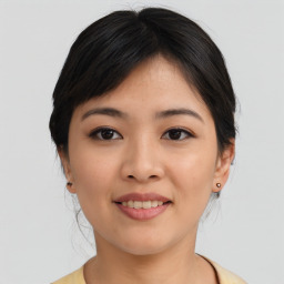 Joyful asian young-adult female with medium  black hair and brown eyes