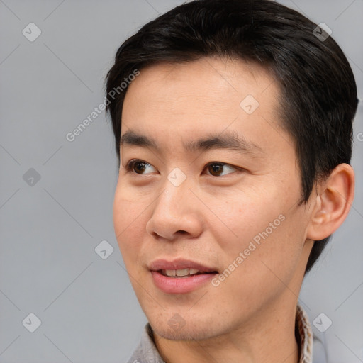 Joyful asian young-adult male with short  brown hair and brown eyes