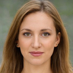 Joyful white young-adult female with long  brown hair and green eyes