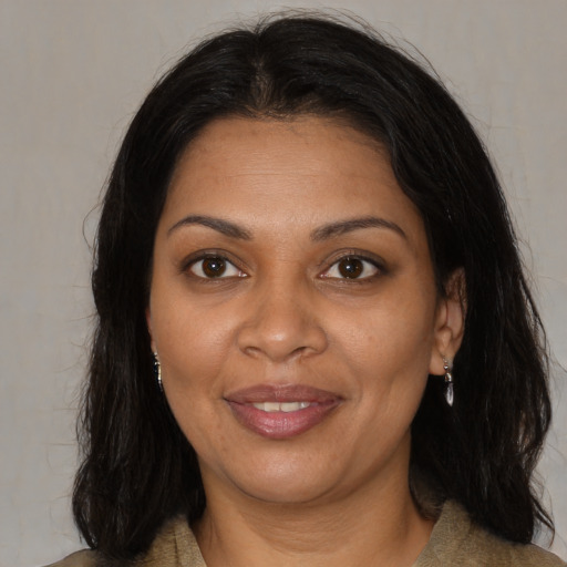 Joyful black young-adult female with medium  brown hair and brown eyes
