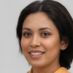 Joyful latino young-adult female with long  brown hair and brown eyes