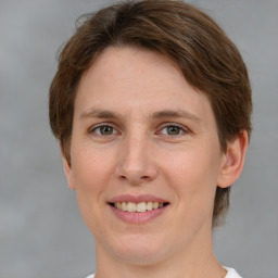 Joyful white young-adult female with medium  brown hair and green eyes