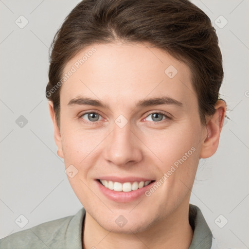 Joyful white young-adult female with short  brown hair and grey eyes