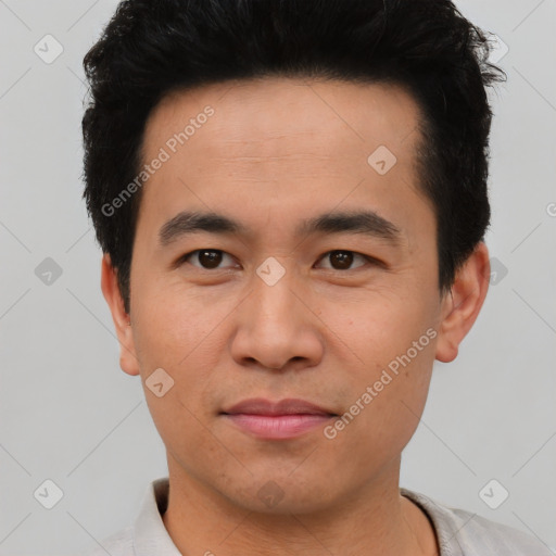 Joyful asian young-adult male with short  black hair and brown eyes