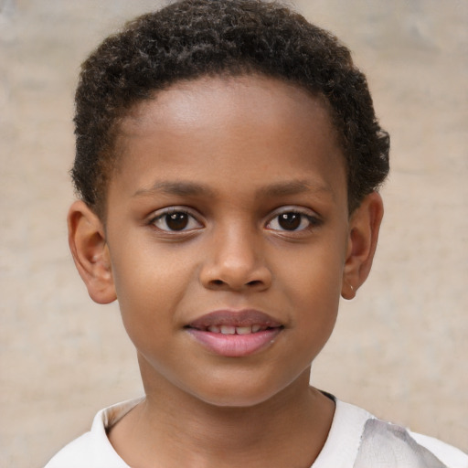 Joyful black child male with short  brown hair and brown eyes