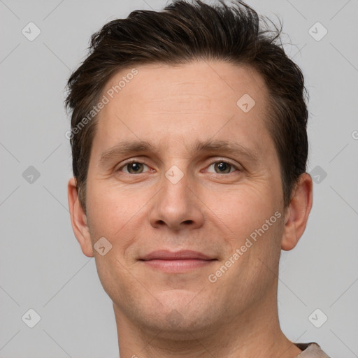 Joyful white adult male with short  brown hair and brown eyes