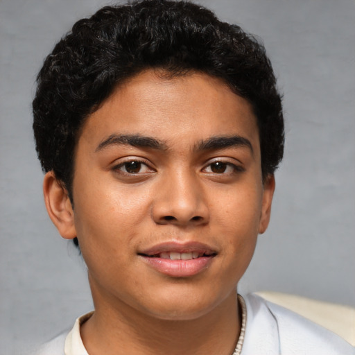 Joyful latino young-adult male with short  brown hair and brown eyes