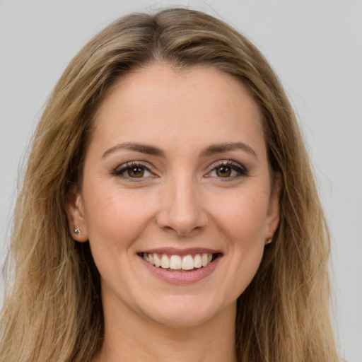 Joyful white young-adult female with long  brown hair and brown eyes