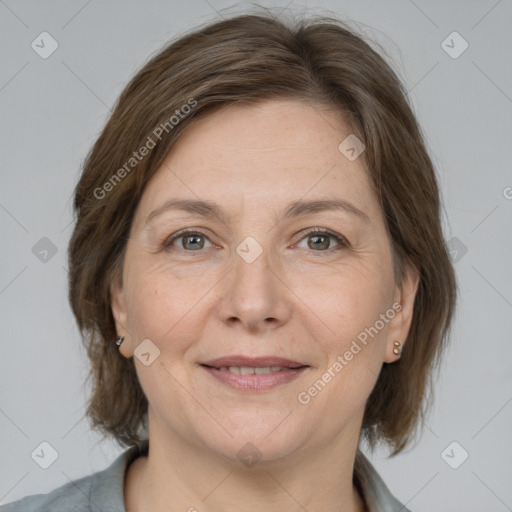 Joyful white adult female with medium  brown hair and grey eyes