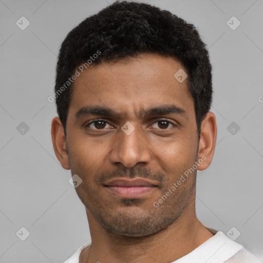 Joyful black young-adult male with short  black hair and brown eyes