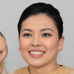 Joyful asian young-adult female with medium  black hair and brown eyes