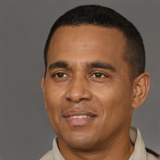 Joyful latino young-adult male with short  brown hair and brown eyes