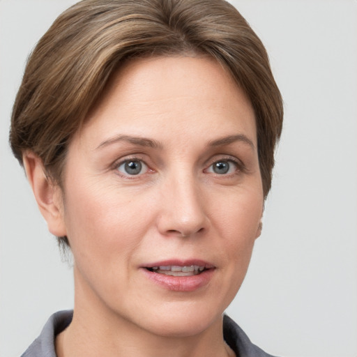 Joyful white adult female with short  brown hair and grey eyes