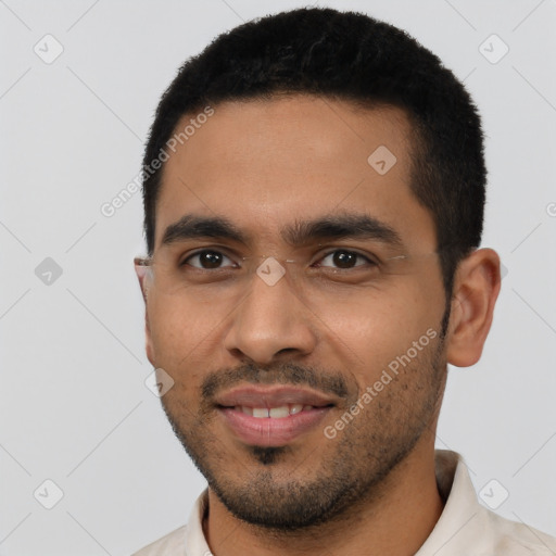 Joyful latino young-adult male with short  black hair and brown eyes