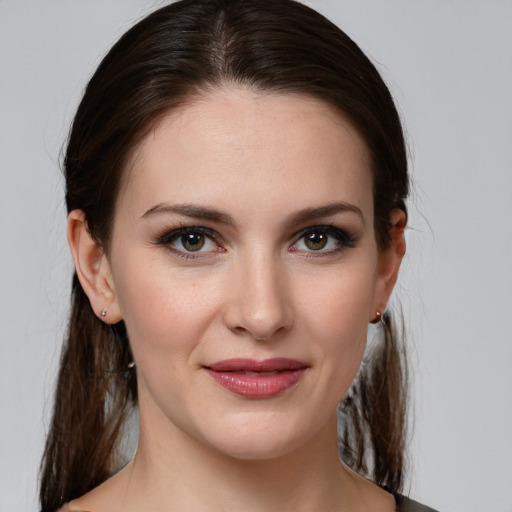 Joyful white young-adult female with medium  brown hair and grey eyes