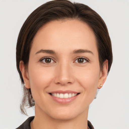 Joyful white young-adult female with medium  brown hair and brown eyes