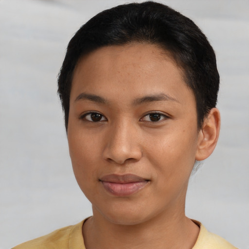 Joyful latino young-adult female with short  black hair and brown eyes