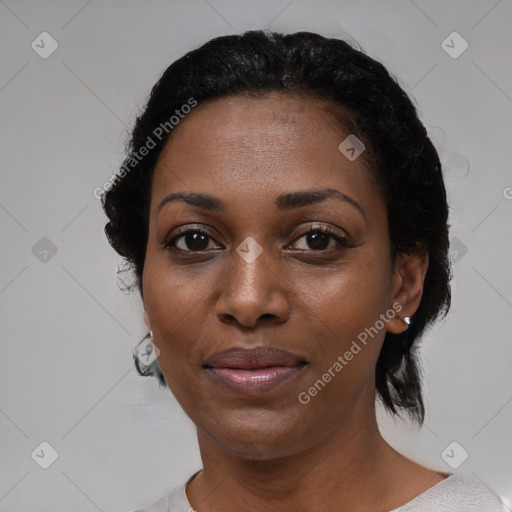 Joyful black adult female with short  black hair and brown eyes