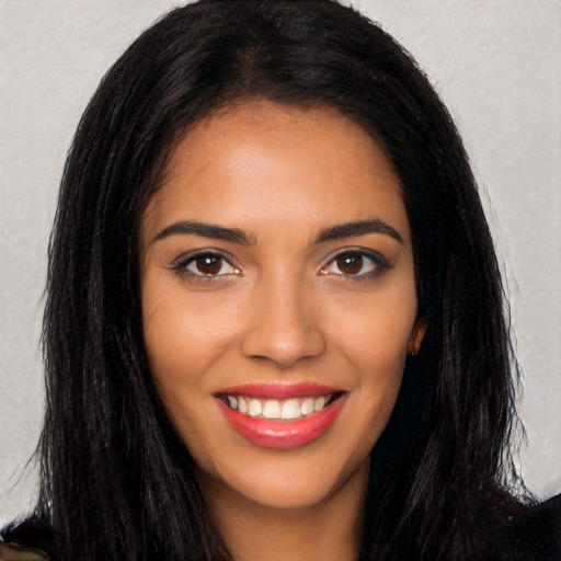 Joyful latino young-adult female with long  brown hair and brown eyes