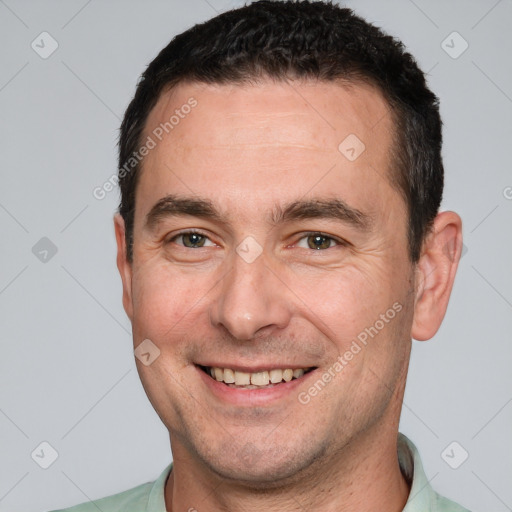 Joyful white adult male with short  brown hair and brown eyes