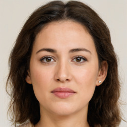 Joyful white young-adult female with long  brown hair and green eyes