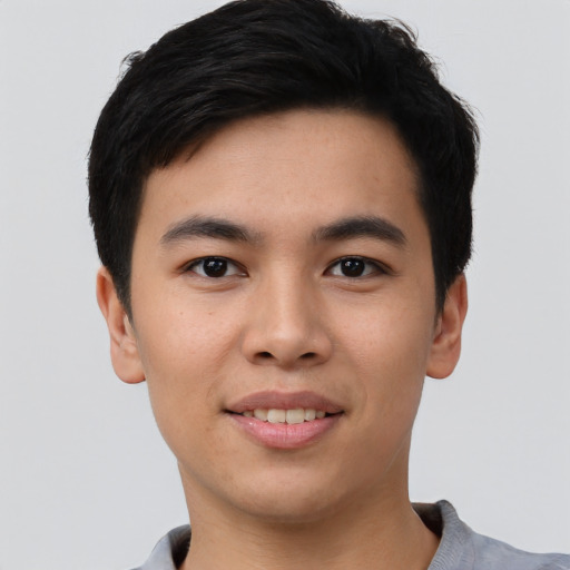 Joyful asian young-adult male with short  black hair and brown eyes