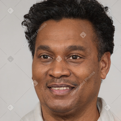 Joyful latino adult male with short  black hair and brown eyes