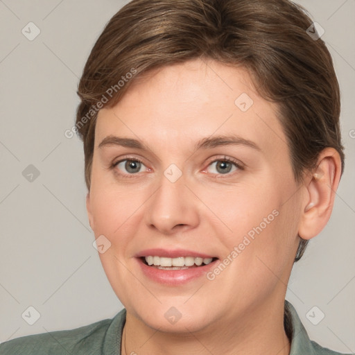 Joyful white young-adult female with short  brown hair and grey eyes