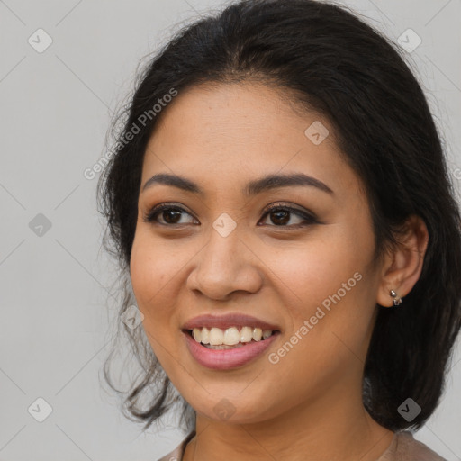 Joyful latino young-adult female with long  brown hair and brown eyes