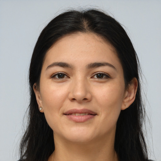 Joyful latino young-adult female with long  brown hair and brown eyes