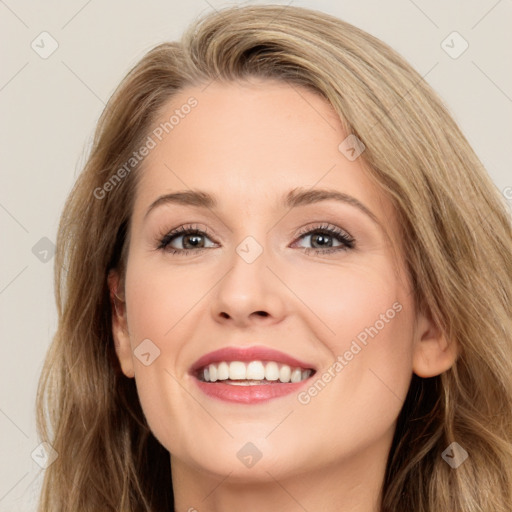 Joyful white young-adult female with long  brown hair and brown eyes