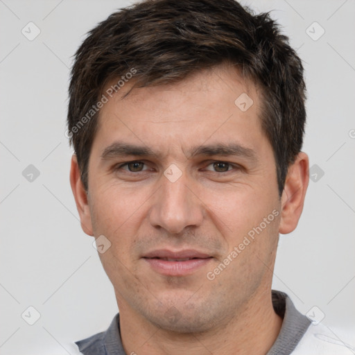 Joyful white adult male with short  brown hair and brown eyes