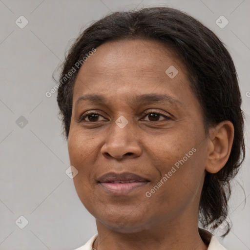 Joyful black adult female with medium  brown hair and brown eyes