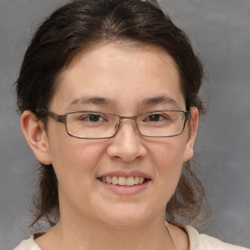 Joyful white adult female with medium  brown hair and brown eyes