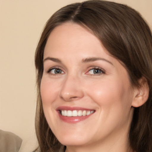 Joyful white young-adult female with medium  brown hair and brown eyes