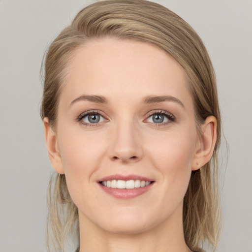 Joyful white young-adult female with long  brown hair and grey eyes