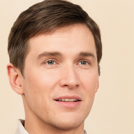 Joyful white young-adult male with short  brown hair and brown eyes