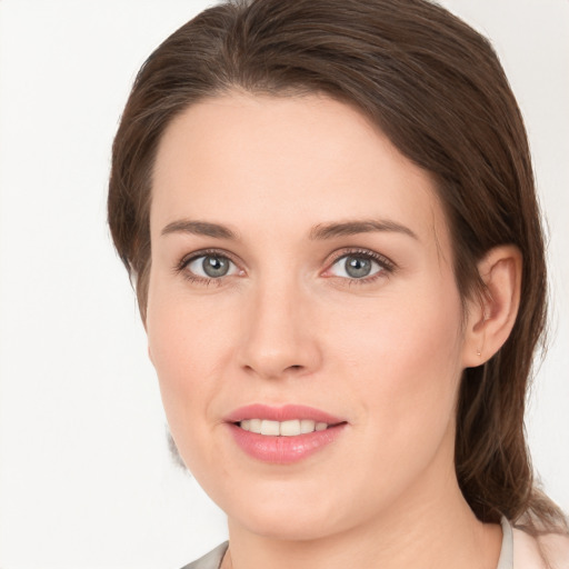 Joyful white young-adult female with medium  brown hair and grey eyes