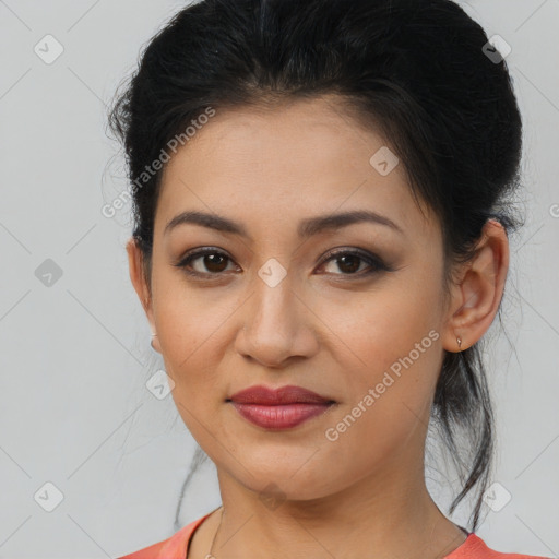 Joyful latino young-adult female with medium  brown hair and brown eyes