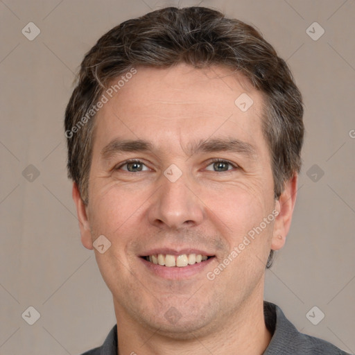 Joyful white adult male with short  brown hair and brown eyes