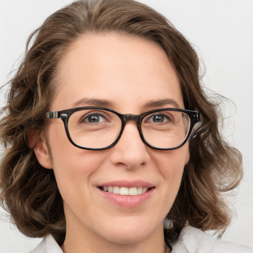 Joyful white adult female with medium  brown hair and blue eyes