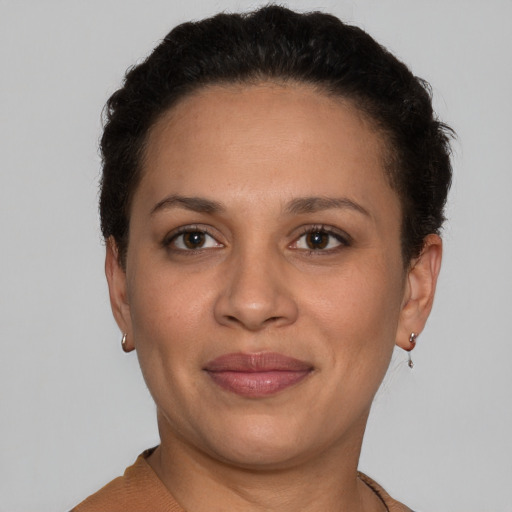 Joyful latino adult female with short  brown hair and brown eyes