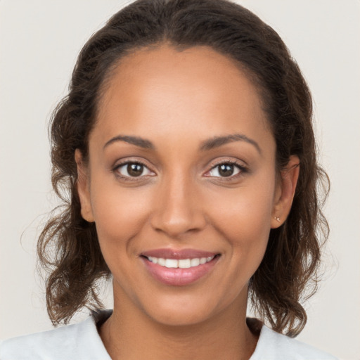 Joyful white young-adult female with long  brown hair and brown eyes