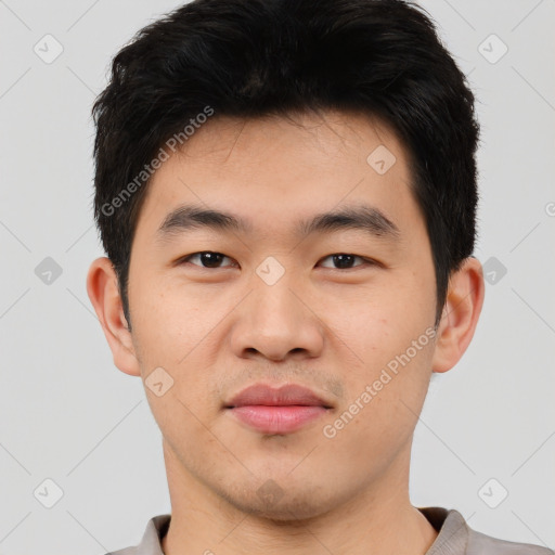 Joyful asian young-adult male with short  black hair and brown eyes