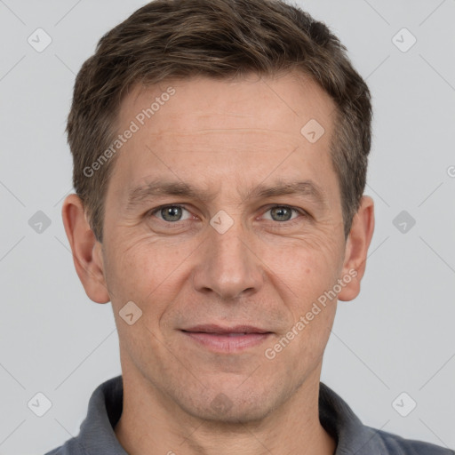 Joyful white adult male with short  brown hair and grey eyes