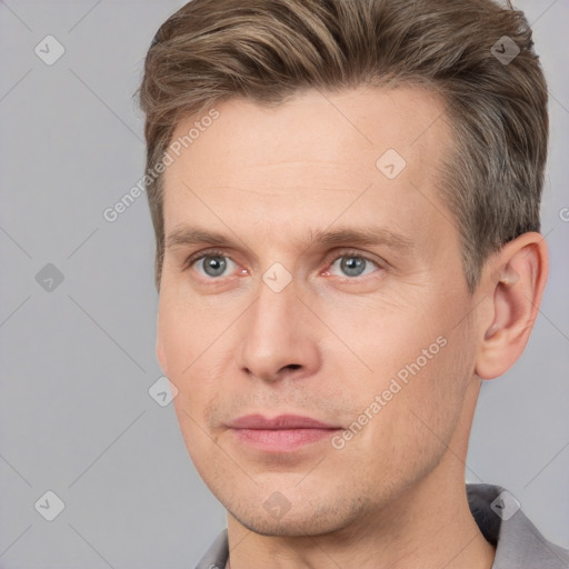 Joyful white adult male with short  brown hair and grey eyes