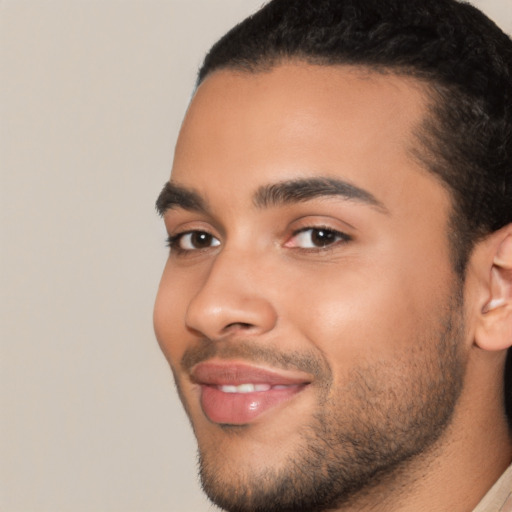 Joyful latino young-adult male with short  black hair and brown eyes