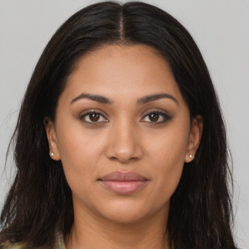 Joyful latino young-adult female with long  brown hair and brown eyes